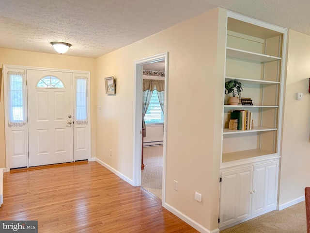 60 Parkwood Dr, Greencastle, PA 17225 - entryway featuring a textured ceiling, a baseboard heating unit, light wood finished floors, and baseboards