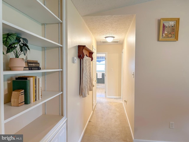 60 Parkwood Dr, Greencastle, PA 17225 - hallway featuring a textured ceiling, light colored carpet, and baseboards