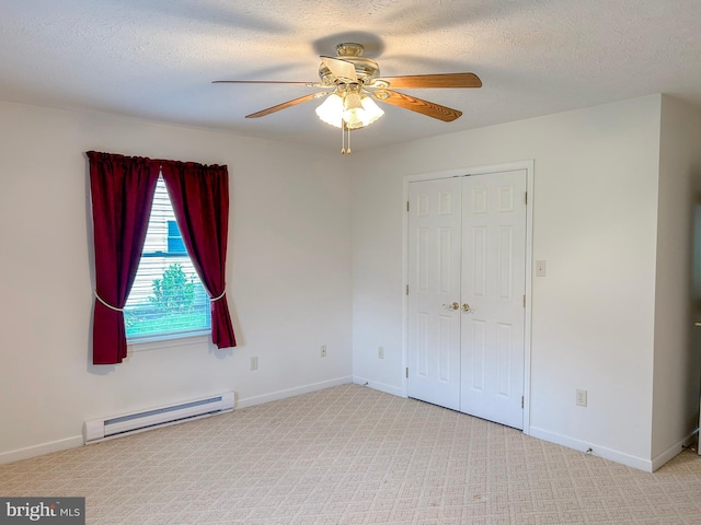 60 Parkwood Dr, Greencastle, PA 17225 - unfurnished bedroom with a baseboard heating unit, a closet, a textured ceiling, carpet, and ceiling fan