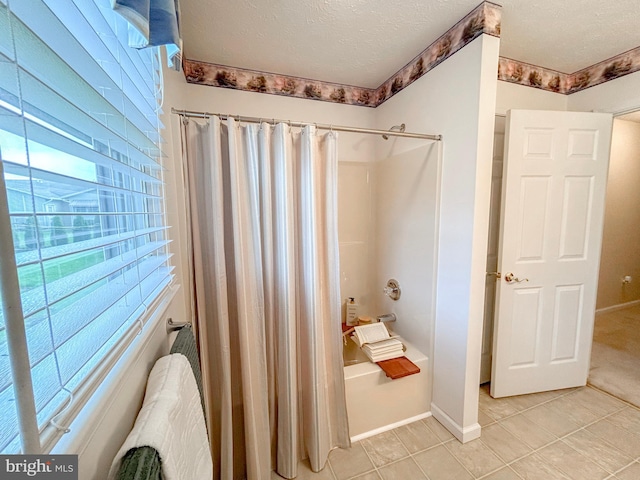 60 Parkwood Dr, Greencastle, PA 17225 - bathroom featuring shower / bath combo with shower curtain, tile patterned flooring, a textured ceiling, and baseboards