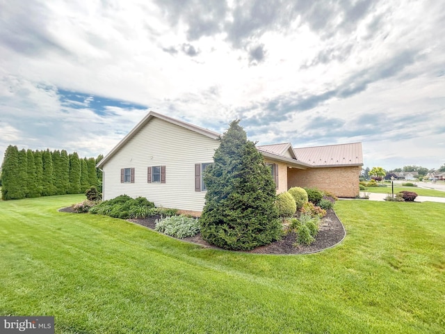 60 Parkwood Dr, Greencastle, PA 17225 - view of side of property with metal roof, a lawn, and brick siding