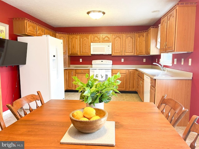60 Parkwood Dr, Greencastle, PA 17225 - kitchen featuring white appliances, a sink, light countertops, and brown cabinets