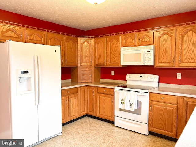 60 Parkwood Dr, Greencastle, PA 17225 - kitchen with white appliances, light countertops, a textured ceiling, and brown cabinetry