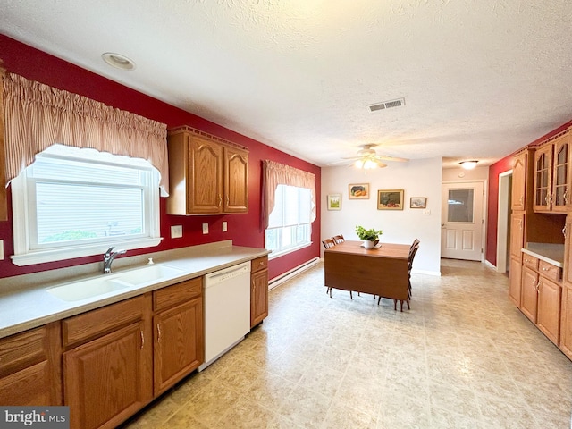 60 Parkwood Dr, Greencastle, PA 17225 - kitchen featuring dishwasher, a sink, a textured ceiling, brown cabinetry, and light countertops