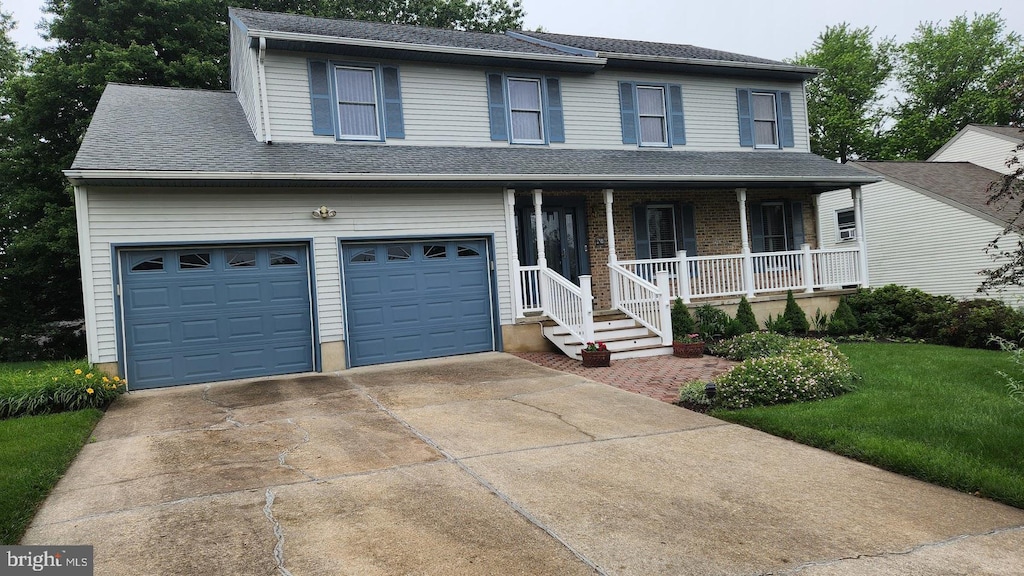 13 Firechase Cir, Newark, DE 19711 - view of front of property featuring covered porch, a garage, concrete driveway, a front yard, and roof with shingles