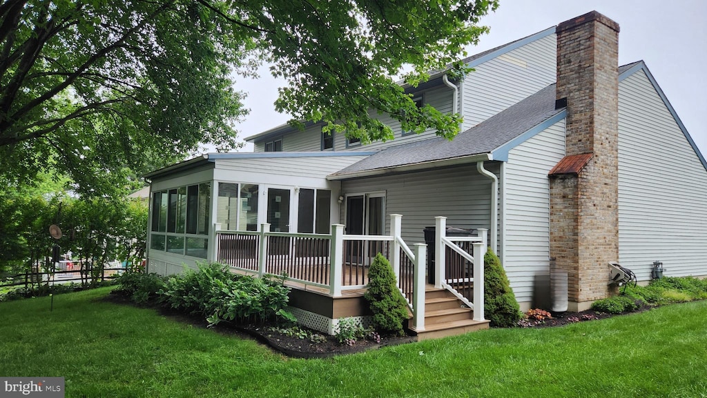 13 Firechase Cir, Newark, DE 19711 - back of house featuring a sunroom, a chimney, a deck, and a yard