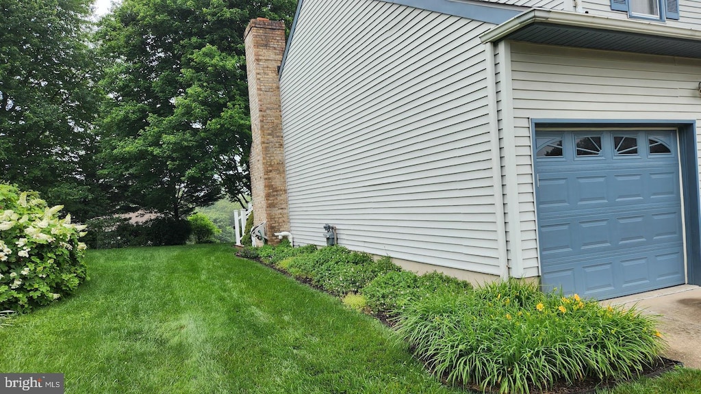 13 Firechase Cir, Newark, DE 19711 - view of side of property featuring a lawn and a garage