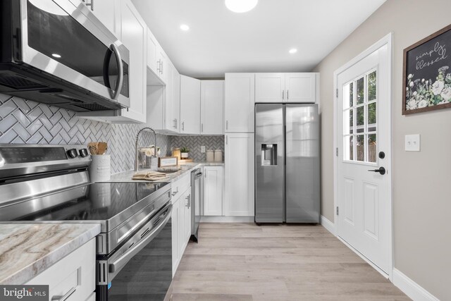 1 Gainor Ave, Maple Shade, NJ 08052 - kitchen with appliances with stainless steel finishes, white cabinetry, tasteful backsplash, light wood-style flooring, and recessed lighting