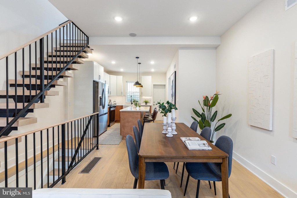 2131 Wharton St, Philadelphia, PA 19146 - dining room featuring light wood-style flooring, baseboards, recessed lighting, and stairway