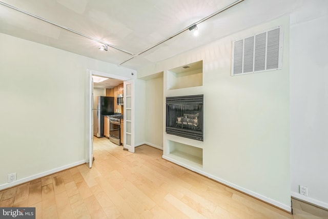 1520 16th St NW Unit 101, Washington, DC 20036 - unfurnished living room with wood finished floors and a fireplace