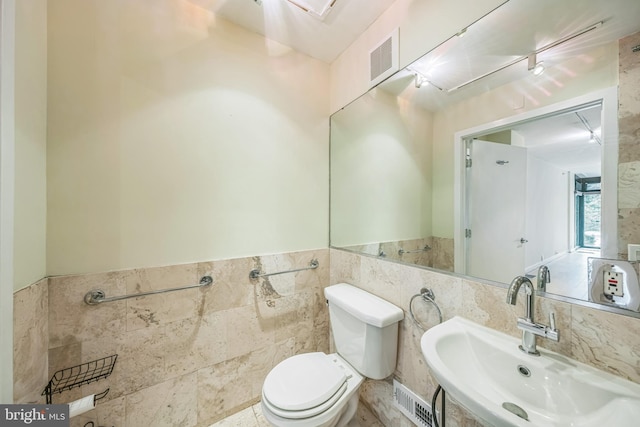 1520 16th St NW Unit 101, Washington, DC 20036 - half bathroom with tile walls and a wainscoted wall