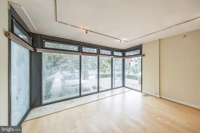 1520 16th St NW Unit 101, Washington, DC 20036 - spare room featuring floor to ceiling windows, wood finished floors, and track lighting