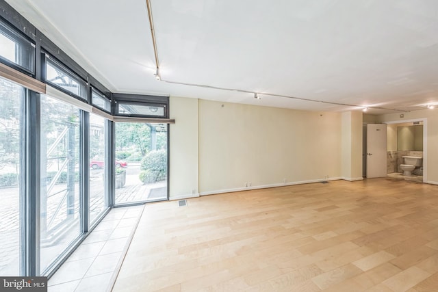 1520 16th St NW Unit 101, Washington, DC 20036 - empty room with rail lighting and light wood-style flooring