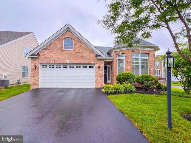 245 Carson Way, Yardley, PA 19067 - traditional-style house with driveway, a front yard, a garage, and brick siding