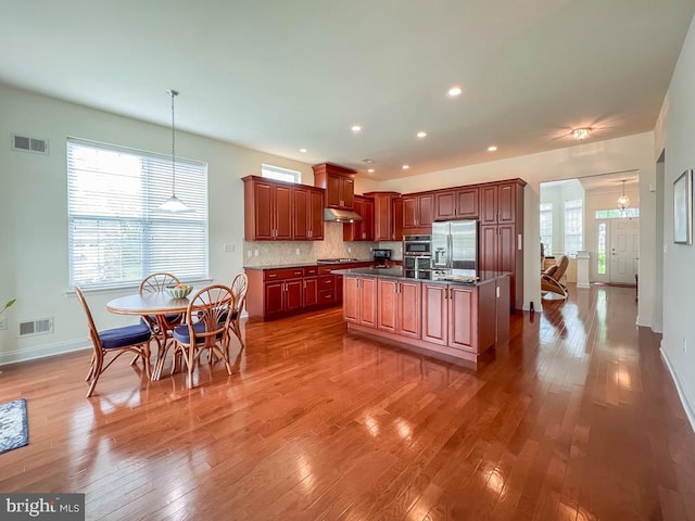 245 Carson Way, Yardley, PA 19067 - kitchen with stainless steel fridge with ice dispenser, under cabinet range hood, light wood-type flooring, baseboards, and cooktop