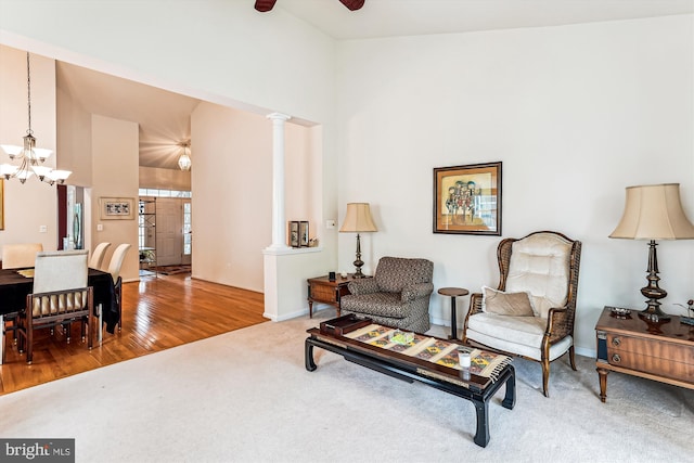 13298 Fieldstone Way, Gainesville, VA 20155 - living area with high vaulted ceiling, a chandelier, ceiling fan, carpet flooring, and decorative columns