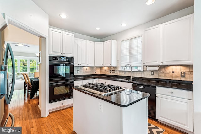 13298 Fieldstone Way, Gainesville, VA 20155 - kitchen with black appliances, white cabinets, decorative backsplash, light wood-type flooring, and recessed lighting