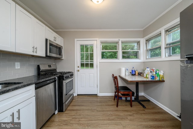 1075 Fireside Ave, Trenton, NJ 08618 - kitchen featuring stainless steel appliances, white cabinetry, decorative backsplash, light wood-style flooring, and crown molding
