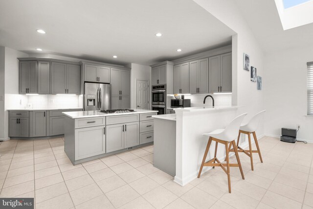 818 Northridge Way, Severna Park, MD 21146 - kitchen with appliances with stainless steel finishes, gray cabinetry, a skylight, light countertops, and recessed lighting