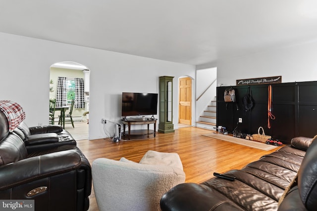 101 Horners Rd, Carlisle, PA 17015 - living room featuring arched walkways, wood finished floors, stairs, and decorative columns