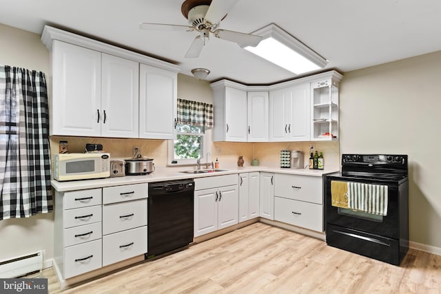 101 Horners Rd, Carlisle, PA 17015 - kitchen with black appliances, a sink, a baseboard heating unit, light wood-style floors, and light countertops
