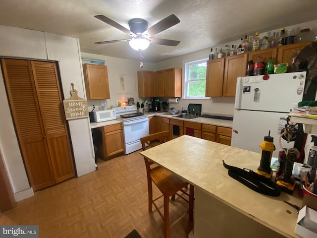 6752 Harding Hwy, Mays Landing, NJ 08330 - kitchen featuring white appliances, light countertops, brown cabinets, ceiling fan, and a breakfast bar area