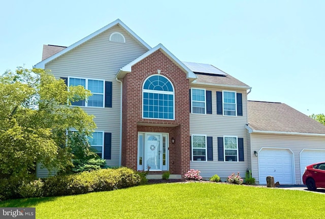 509 W Reeser St, Leesport, PA 19533 - view of front of house with an attached garage, roof mounted solar panels, a front lawn, and a shingled roof