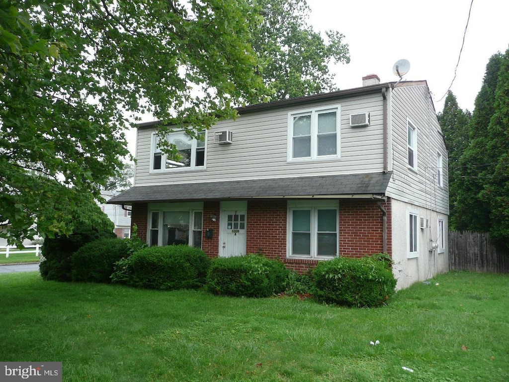 1009 W Moreland Rd, Willow Grove, PA 19090 - view of front of house featuring brick siding, a chimney, and an AC wall unit