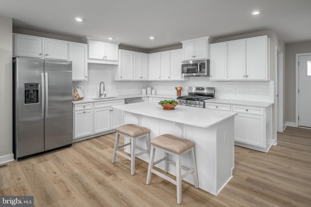 642A Shannon Dr S, Greencastle, PA 17225 - kitchen with stainless steel appliances, a sink, light countertops, decorative backsplash, and light wood finished floors