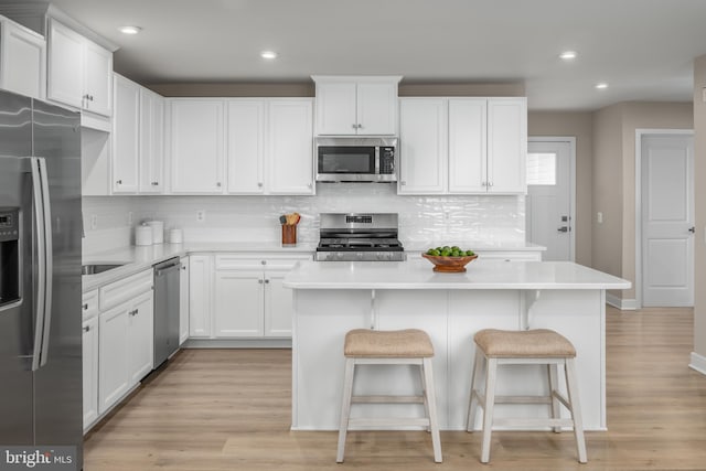 642A Shannon Dr S, Greencastle, PA 17225 - kitchen with appliances with stainless steel finishes, light countertops, tasteful backsplash, a kitchen island, and recessed lighting