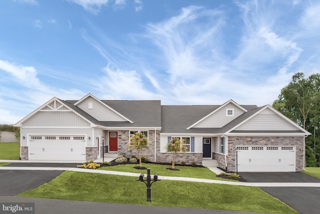 642A Shannon Dr S, Greencastle, PA 17225 - view of front of house with stone siding, driveway, a front lawn, an attached garage, and roof with shingles