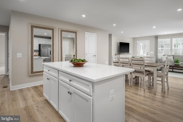 642A Shannon Dr S, Greencastle, PA 17225 - kitchen featuring stainless steel refrigerator with ice dispenser, light wood-style flooring, white cabinetry, a center island, and recessed lighting
