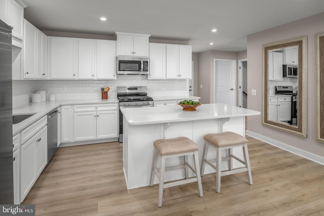 642A Shannon Dr S, Greencastle, PA 17225 - kitchen with stainless steel appliances, recessed lighting, a kitchen island, a breakfast bar area, and tasteful backsplash