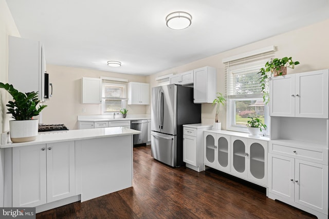 245 Spout Spring Ave, Lumberton, NJ 08048 - kitchen with appliances with stainless steel finishes, light countertops, white cabinets, a peninsula, and dark wood-type flooring