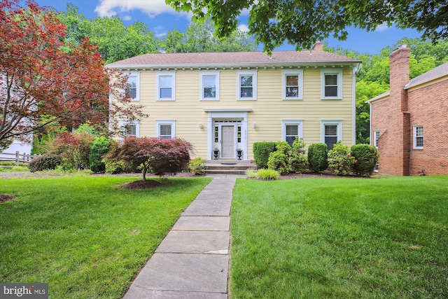 9417 Reach Rd, Potomac, MD 20854 - colonial inspired home with a front yard and a chimney