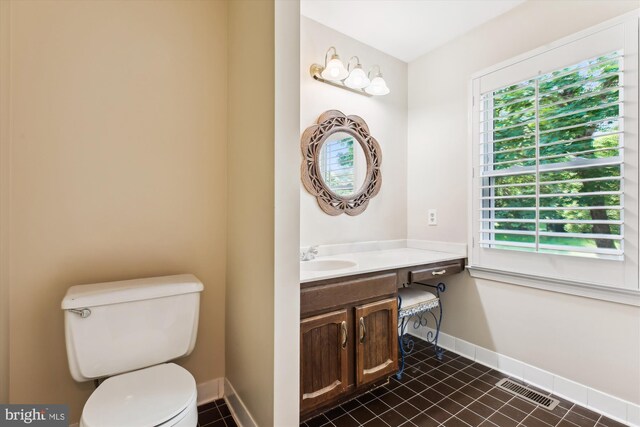 9417 Reach Rd, Potomac, MD 20854 - half bath with toilet, vanity, baseboards, and tile patterned flooring