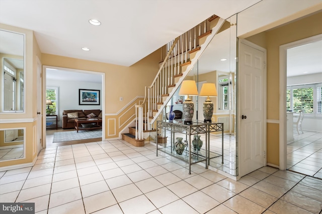 9417 Reach Rd, Potomac, MD 20854 - stairs with tile patterned floors, recessed lighting, and wainscoting
