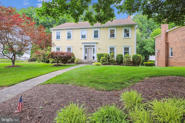 9417 Reach Rd, Potomac, MD 20854 - colonial home featuring a front yard and a chimney