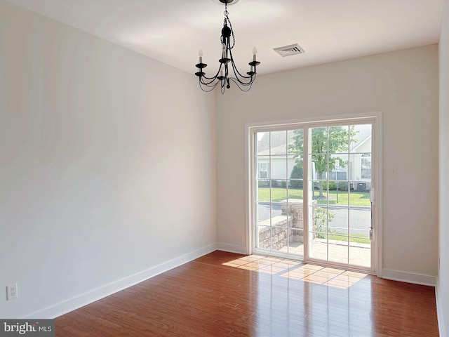 1039 Burgundy Cir, Pennsburg, PA 18073 - empty room with a chandelier and wood finished floors