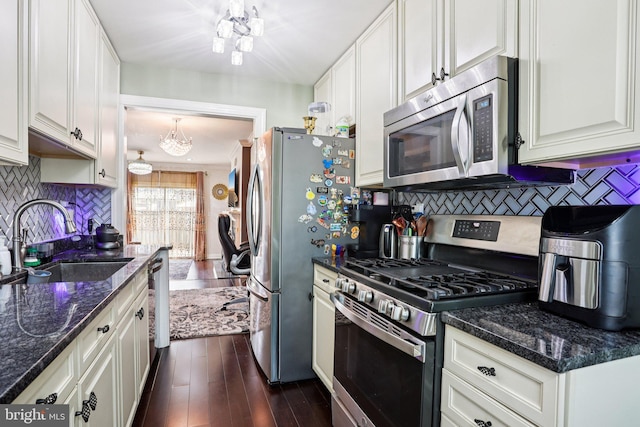 2203 Pyle St, Wilmington, DE 19805 - kitchen featuring stainless steel appliances, a chandelier, and white cabinetry