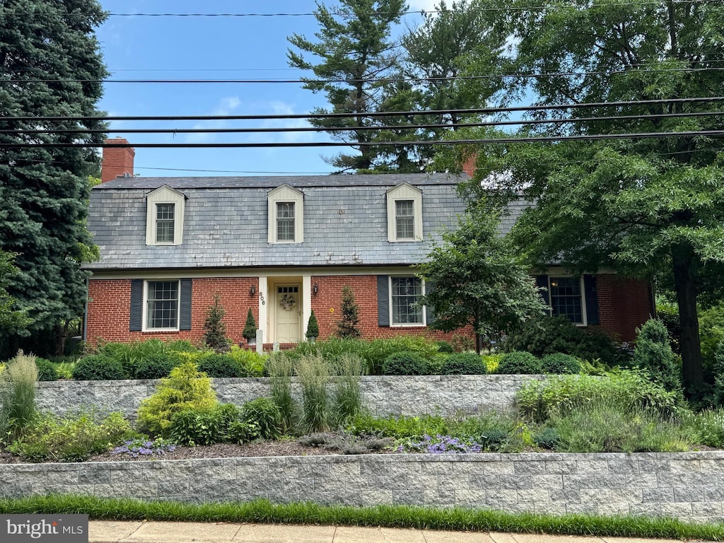 806 W Lake Ave, Baltimore, MD 21210 - view of front of property with brick siding, a chimney, and a high end roof