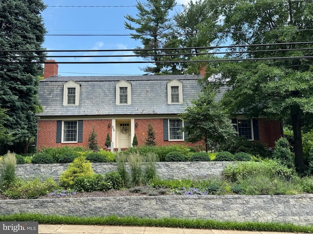 806 W Lake Ave, Baltimore, MD 21210 - view of front of property with brick siding, a chimney, and a high end roof