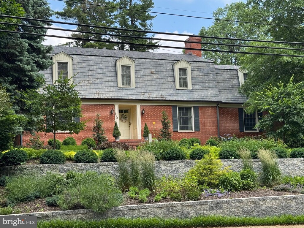 806 W Lake Ave, Baltimore, MD 21210 - view of front facade with brick siding, mansard roof, and a chimney