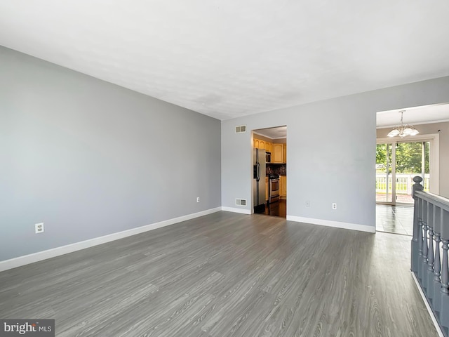 17 Butternut Ln, Hanover, PA 17331 - unfurnished living room featuring a chandelier, baseboards, and dark wood finished floors