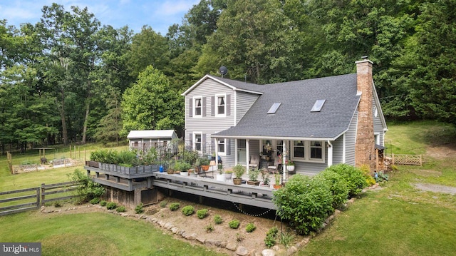 206 English Muffin Ct, Berkeley Springs, WV 25411 - back of property featuring a wooden deck, roof with shingles, a chimney, and an outdoor structure