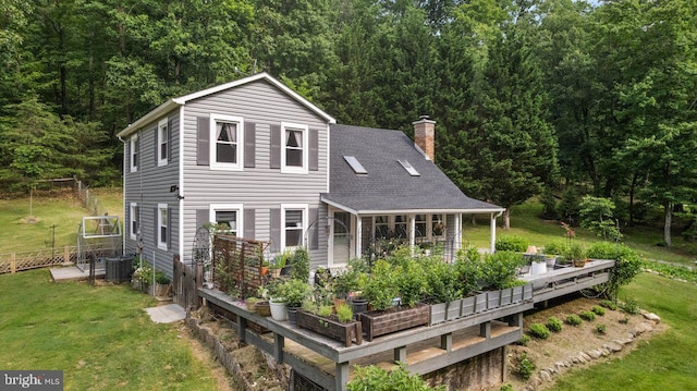 206 English Muffin Ct, Berkeley Springs, WV 25411 - rear view of house with a chimney, cooling unit, roof with shingles, a wooden deck, and a view of trees