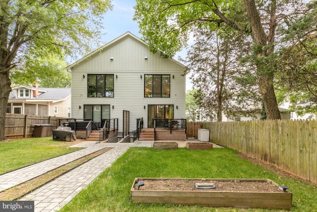 4020 35th St Unit B, Mount Rainier, MD 20712 - back of house featuring a garden, a fenced backyard, and a wooden deck