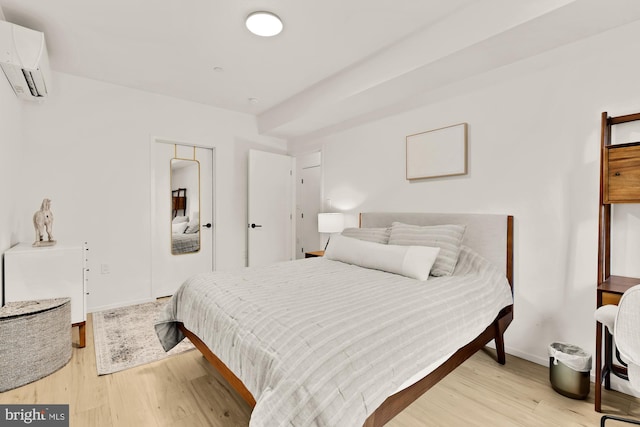 4020 35th St Unit B, Mount Rainier, MD 20712 - bedroom with a wall mounted air conditioner and light wood-style floors