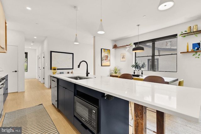 4020 35th St Unit B, Mount Rainier, MD 20712 - kitchen featuring black microwave, light wood-style flooring, dark cabinets, decorative light fixtures, and recessed lighting