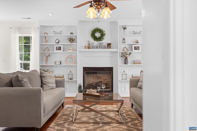 366 Saint Ivy Ave, Troy, VA 22974 - living area with ceiling fan, dark wood-style flooring, a glass covered fireplace, and built in shelves